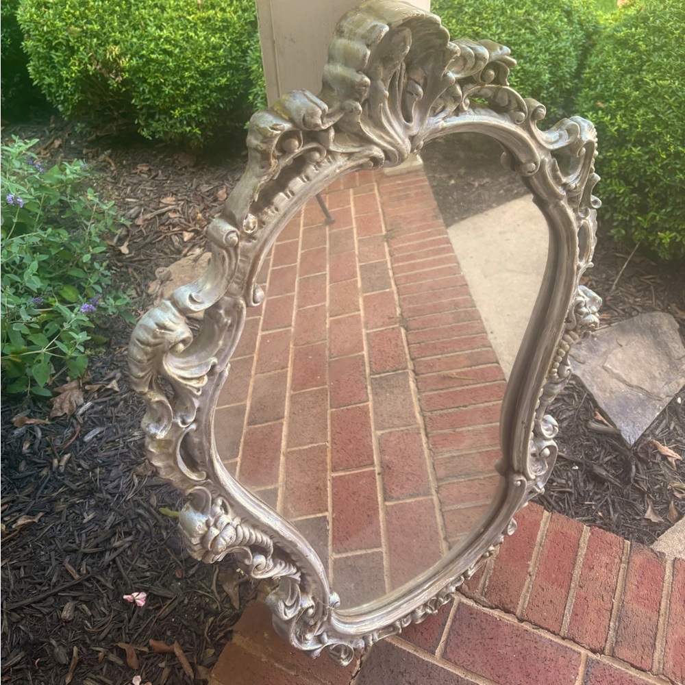 A beautifully antique carved Italian wood mirror.